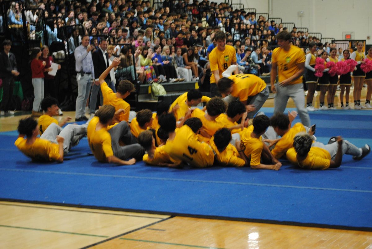 The boys soccer team takes on the fall pep rally with a silly entrance, rolling in with excitement for their season.