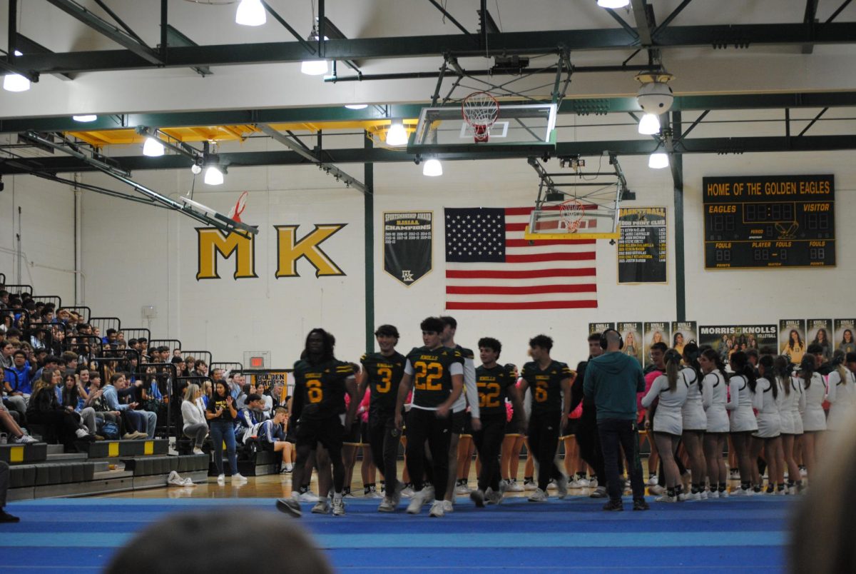 The Varisty Boys Football team walks out, getting ready and hype for their game over the weekend. 